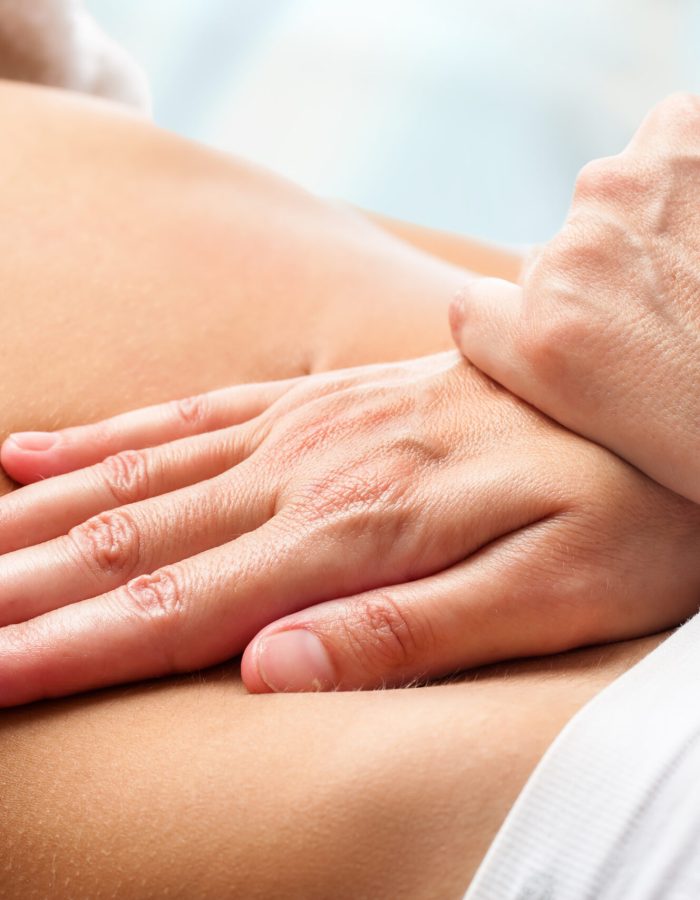 Osteopathic belly massage. Macro close up of Osteopathic belly massage.